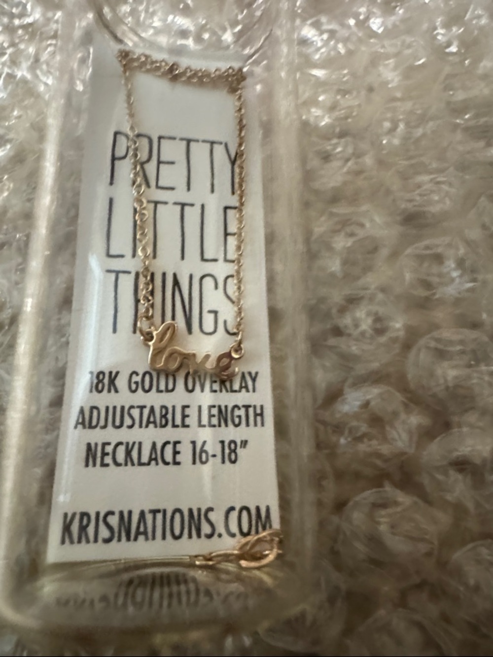 Kris Nations “love” necklace